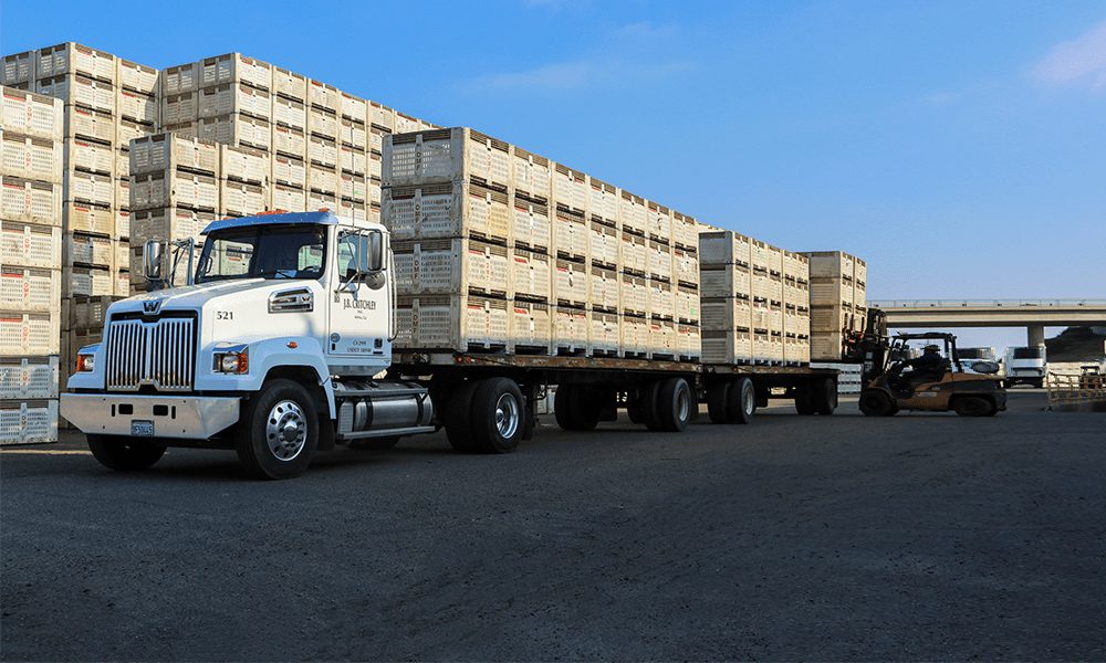 J.B. Critchley flatbed truck loaded with stacked produce bins